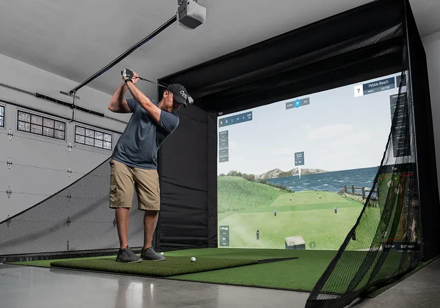 Carl's Place DIY golf simulator enclosure set up in a home