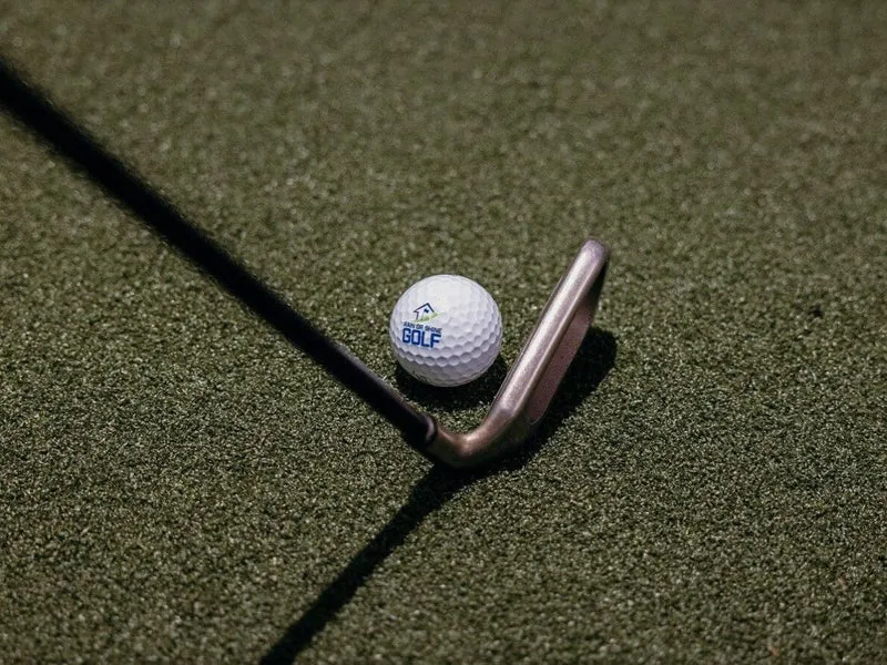 SwingTurf golf hitting mat in a home simulator